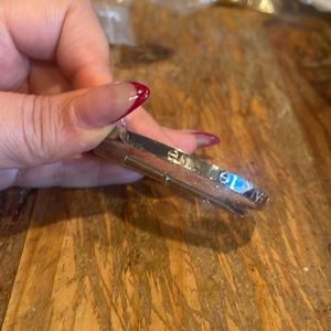 Nail head silver bangle with screwdriver tool to open and close. Size 17.